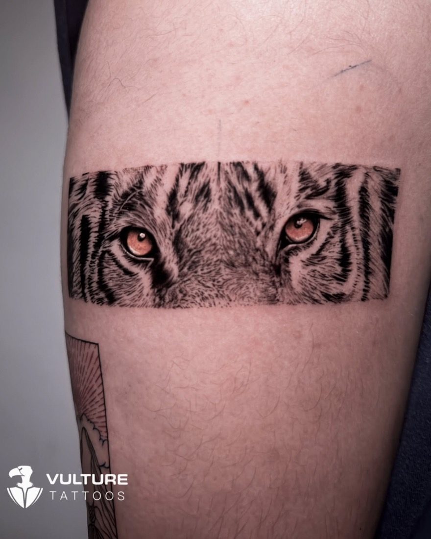 Tiger Eyes Realism Armband — tattoo by Vulture Tattoos, Gurugram