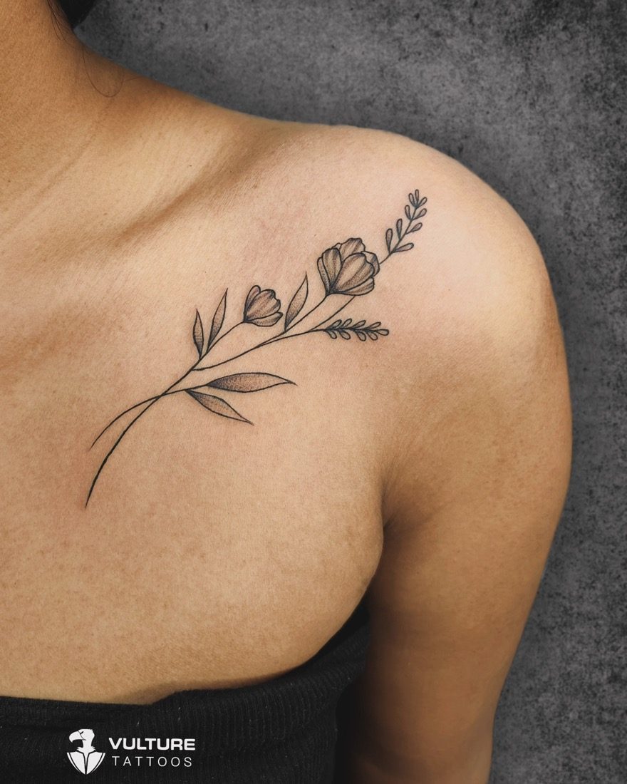 Fine-Line Floral Collarbone Spray — tattoo by Vulture Tattoos, Gurugram