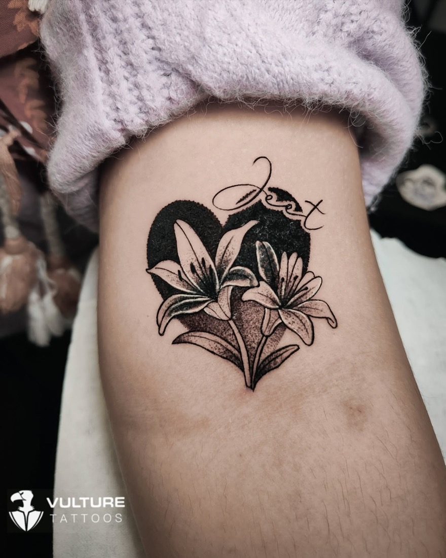 Lily Heart With Script Name — tattoo by Vulture Tattoos, Gurugram