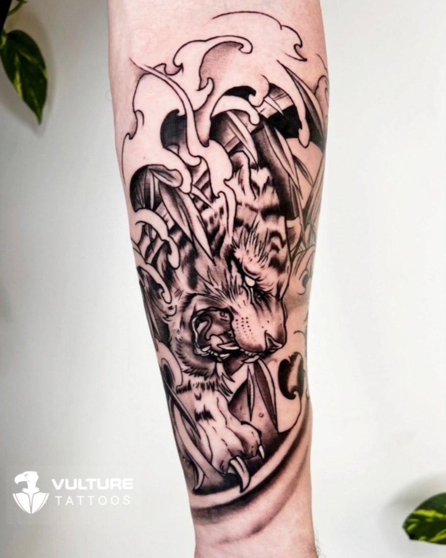 Snarling Tiger With Waves — tattoo by Vulture Tattoos, Gurugram