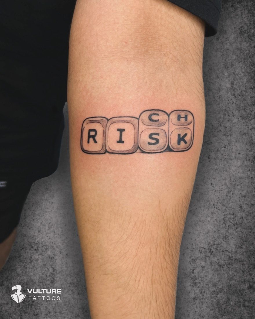 Rich Risk Dice Lettering — tattoo by Vulture Tattoos, Gurugram
