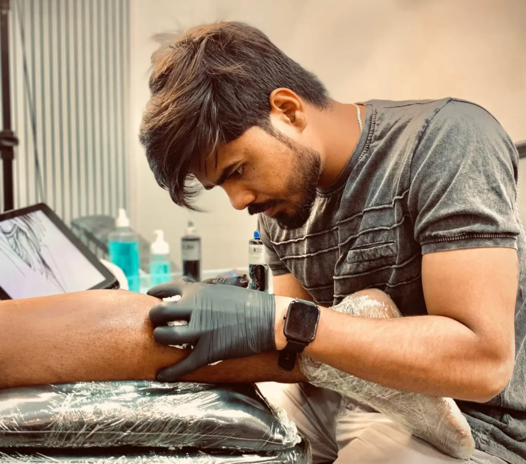 best tattoo artist in Gurgaon tattooing client