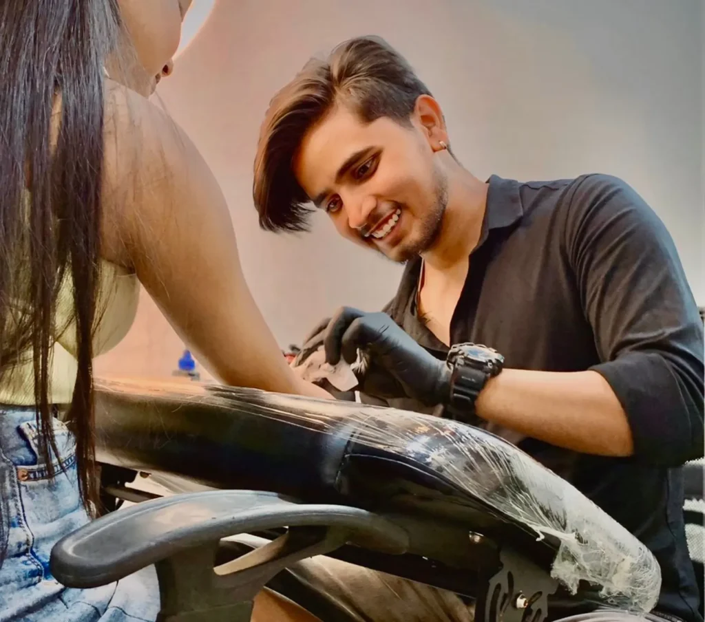 best tattoo artist in Gurgaon tattooing client