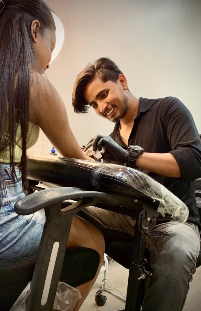 Angel wings tattoo across the shoulder blades in black and grey, Gurgaon
