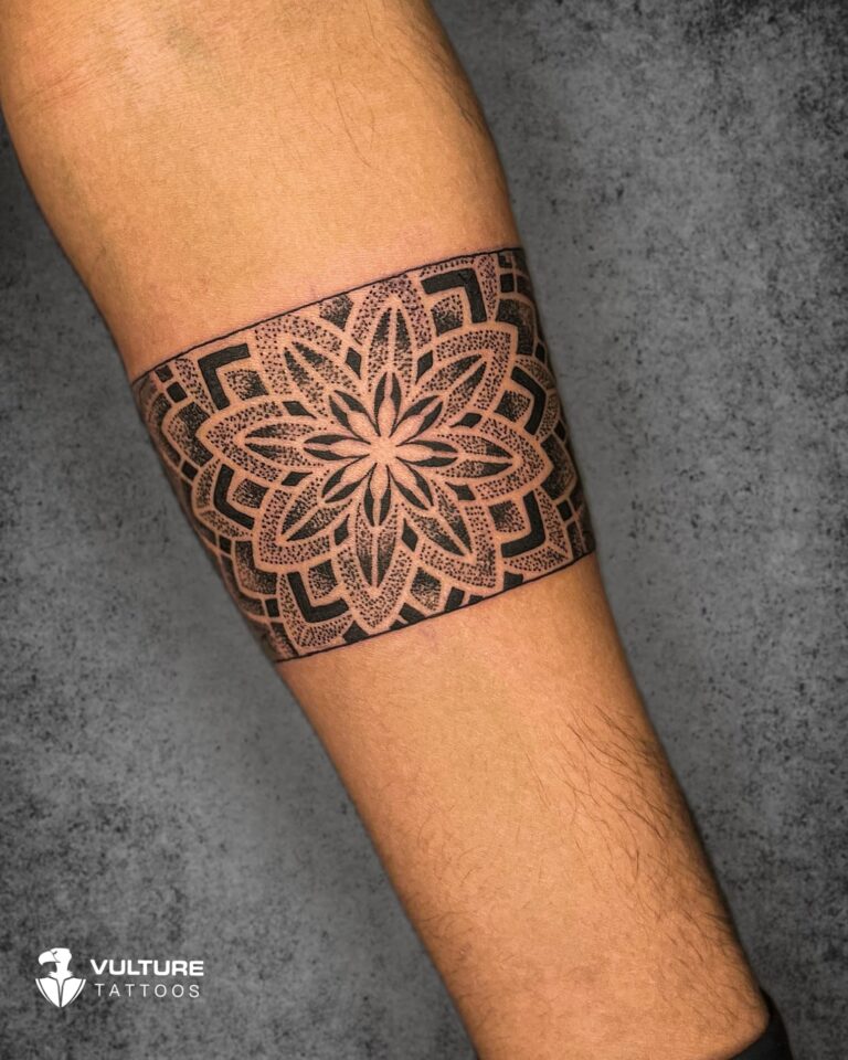 Ornamental fine-line armband tattoo wrapping the upper arm, Gurgaon