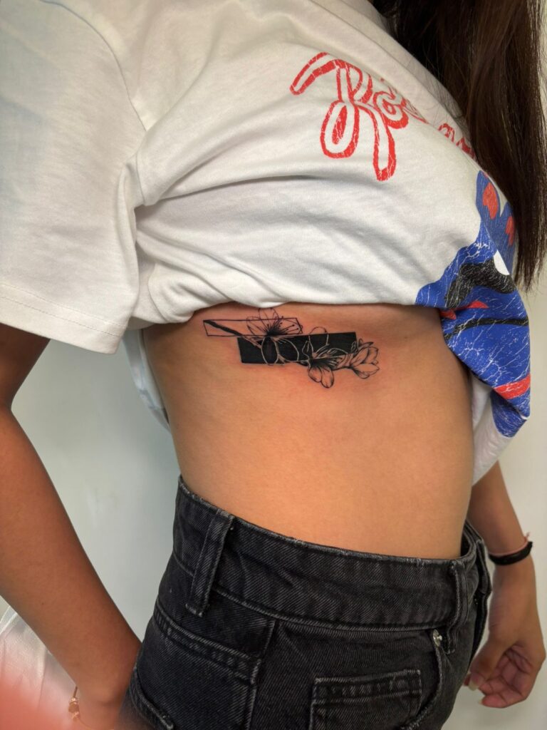 Fine-line floral rib tattoo, Vulture Tattoos Gurgaon