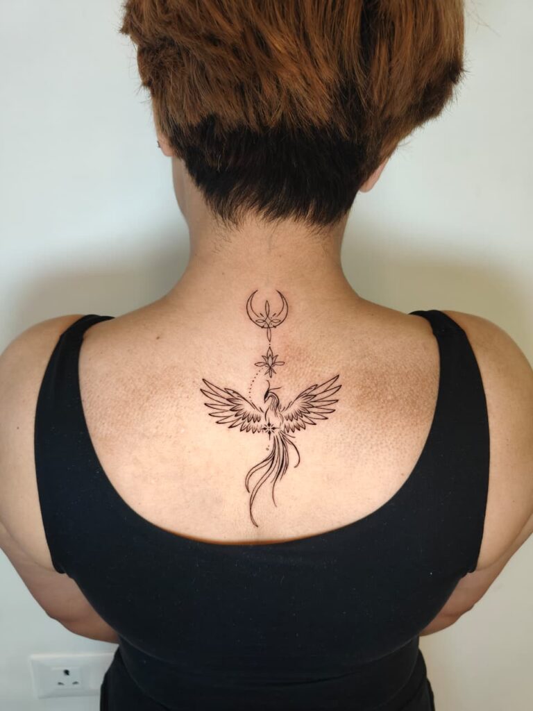 Fine-line spine tattoo running down the centre of the back, Gurgaon