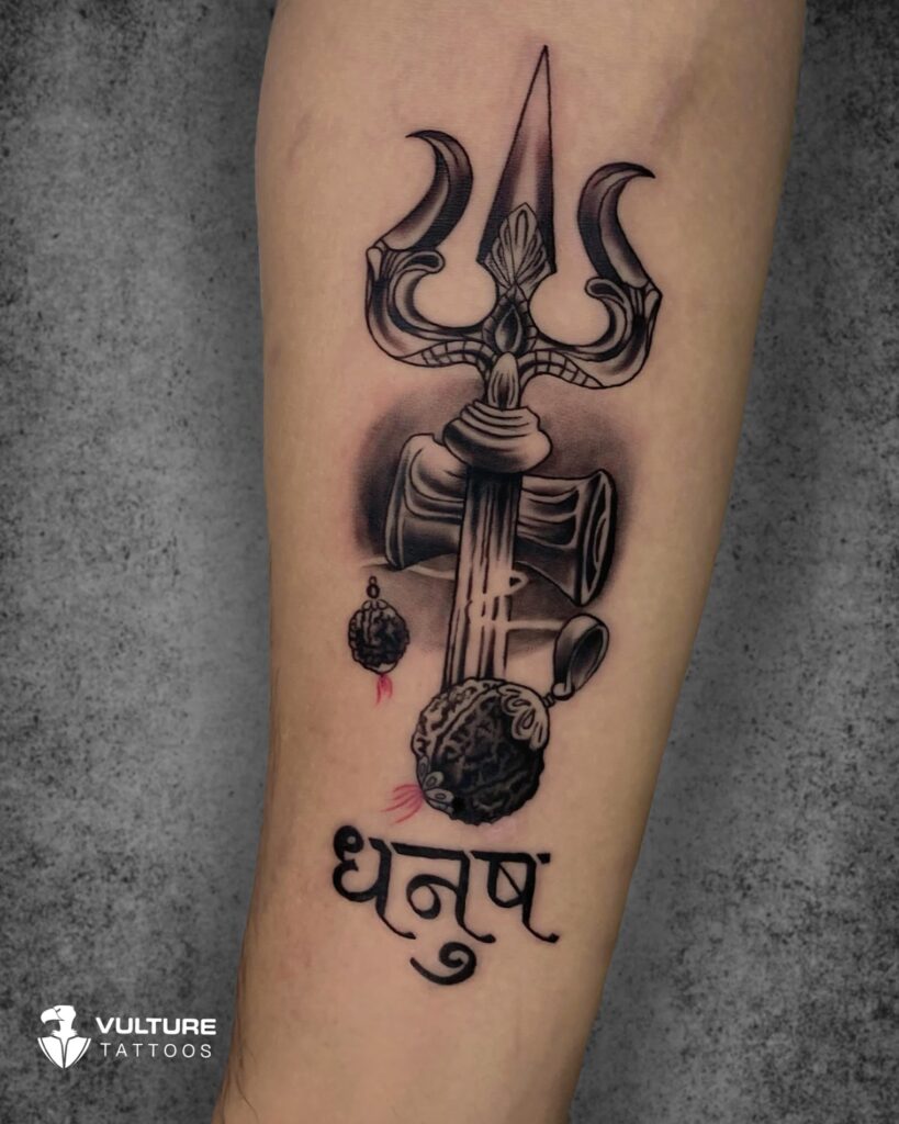 Trishul tattoo with damru and rudraksha beads on forearm, Gurgaon